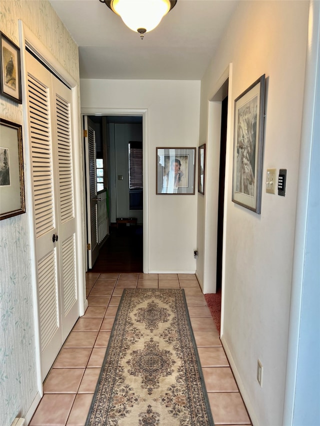 hall with light tile patterned floors