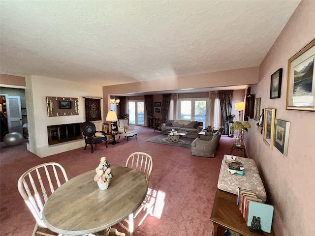 carpeted dining area featuring a textured ceiling