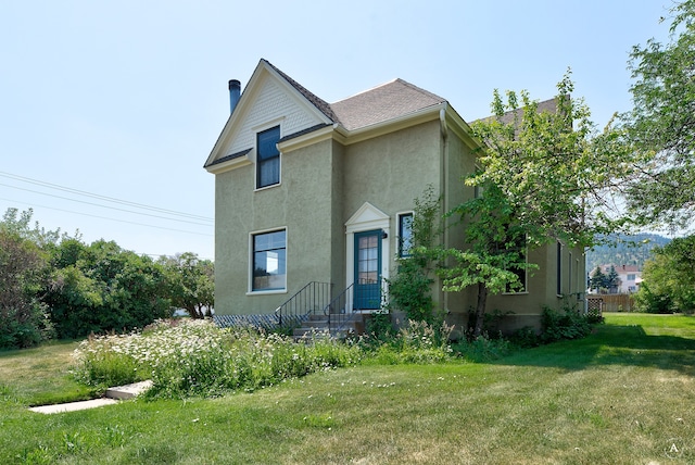 view of side of home featuring a lawn