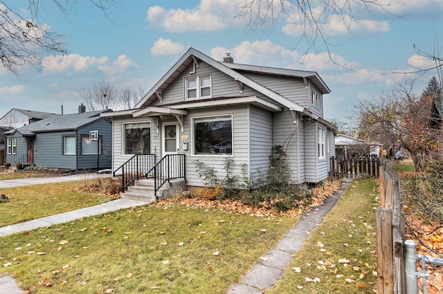 bungalow-style house featuring a front lawn