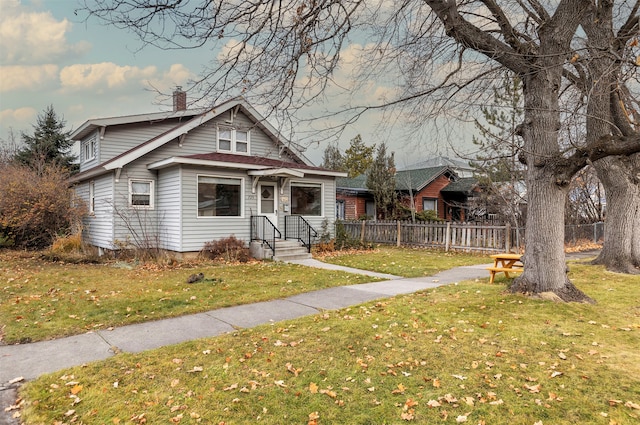 bungalow-style home featuring a front yard