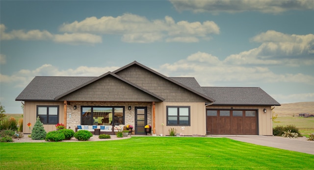 craftsman house with a front lawn and a garage