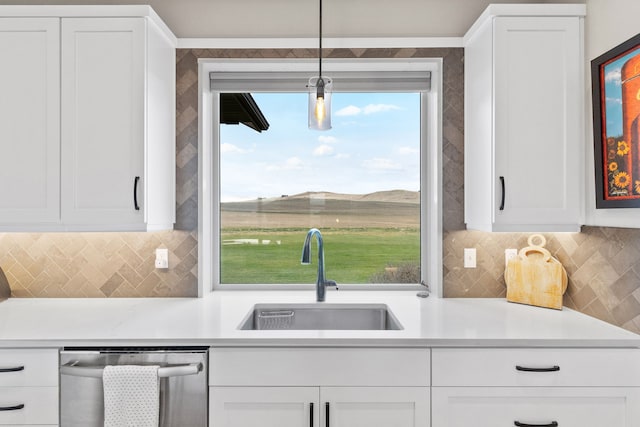 kitchen featuring a mountain view, sink, hanging light fixtures, stainless steel dishwasher, and white cabinetry