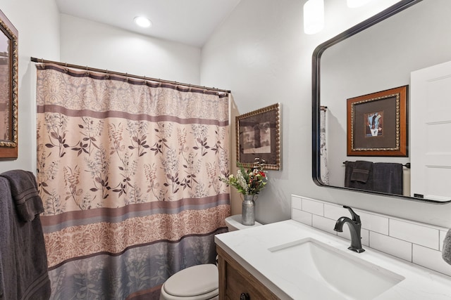 bathroom with vanity, curtained shower, toilet, and backsplash