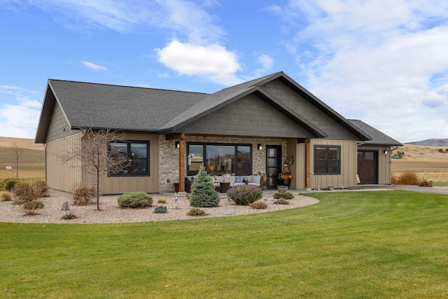 view of front of property with a front yard and a garage