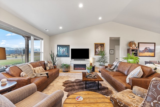 living room with light hardwood / wood-style floors and lofted ceiling