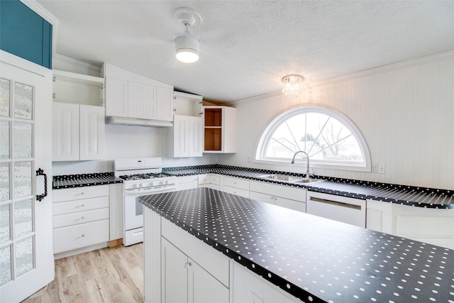 kitchen with sink, white appliances, white cabinets, and crown molding