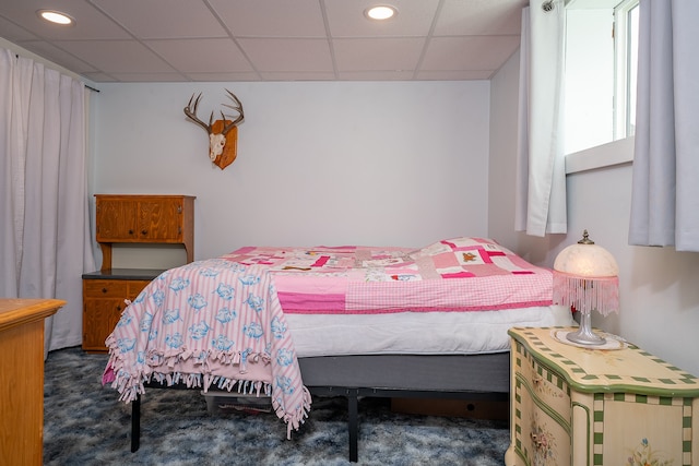 carpeted bedroom with a paneled ceiling