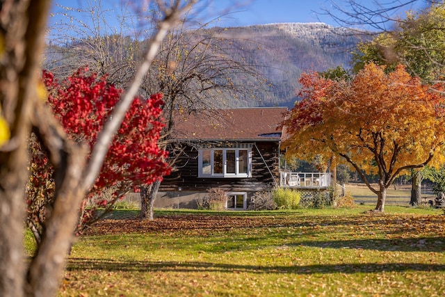 4 Courtier Rd, Thompson Falls, MT 59873 - view of front of house with a front yard and a deck with mountain view