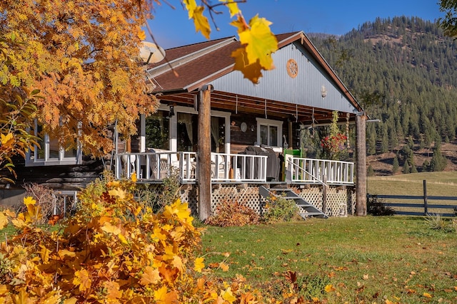 4 Courtier Rd, Thompson Falls, MT 59873 - view of front facade featuring a porch, a forest view, and a mountain view