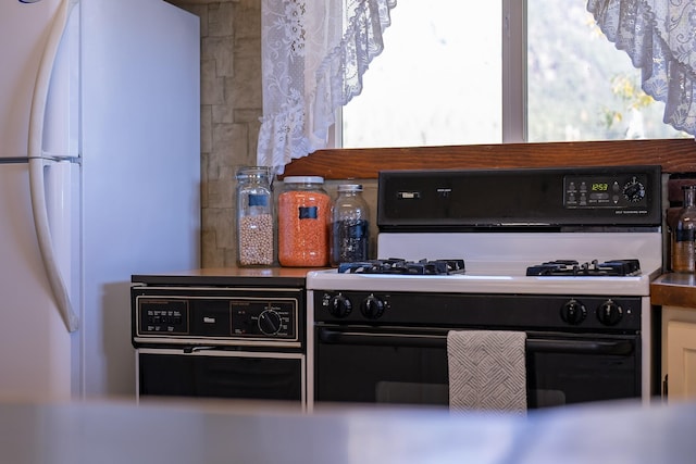 4 Courtier Rd, Thompson Falls, MT 59873 - kitchen featuring gas range oven and freestanding refrigerator