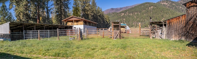 4 Courtier Rd, Thompson Falls, MT 59873 - view of yard featuring a mountain view, an exterior structure, and an outbuilding