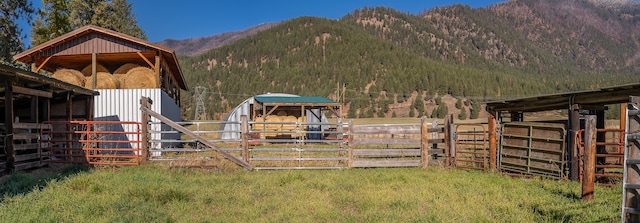 view of horse barn featuring a mountain view