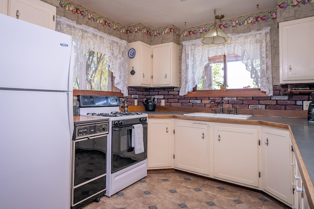 4 Courtier Rd, Thompson Falls, MT 59873 - kitchen with white appliances, a sink, white cabinetry, healthy amount of natural light, and wallpapered walls