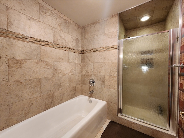 bathroom featuring separate shower and tub