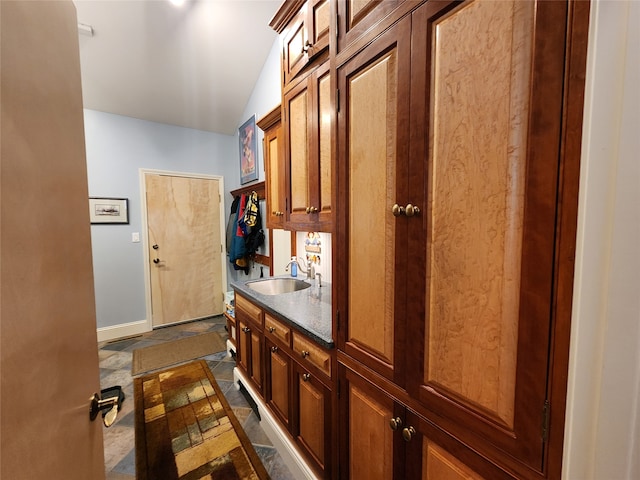 interior space featuring sink and vaulted ceiling