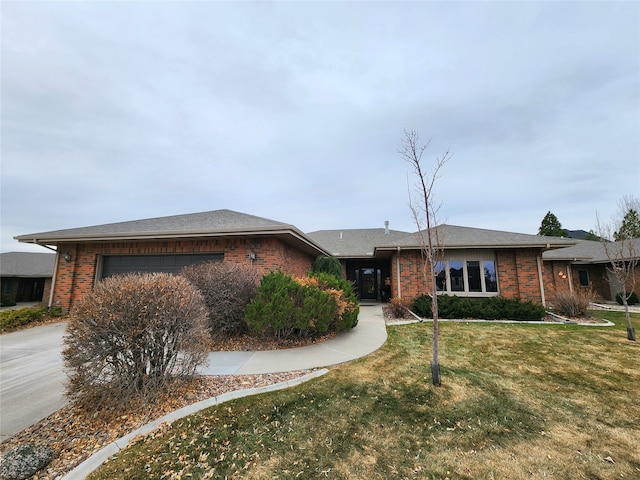 single story home featuring a garage and a front lawn