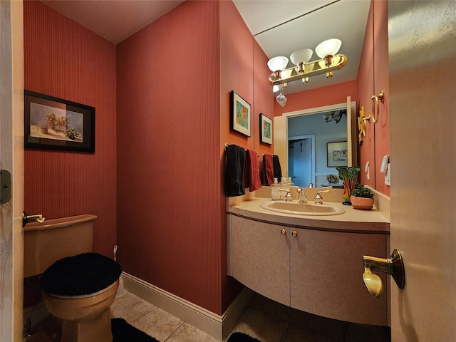 bathroom featuring tile patterned flooring, vanity, and toilet