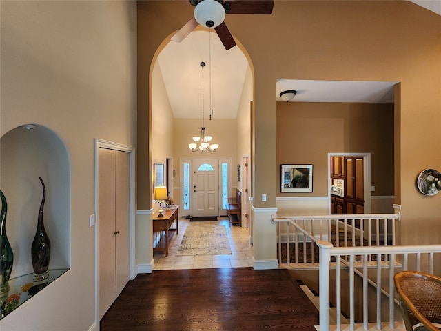 foyer featuring a chandelier, high vaulted ceiling, and light hardwood / wood-style flooring