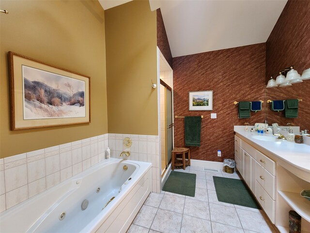 bathroom featuring tile patterned floors, vanity, plus walk in shower, and vaulted ceiling