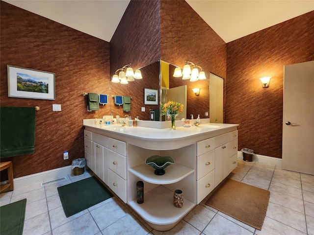 bathroom featuring vanity, tile patterned floors, and lofted ceiling