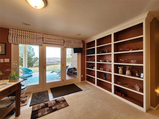 entryway featuring light colored carpet