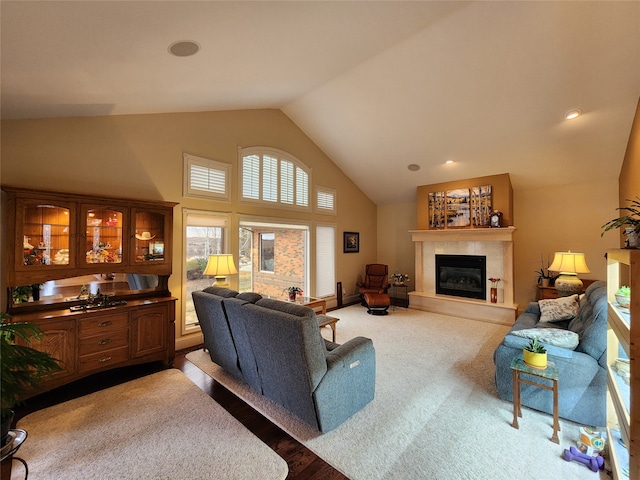 living room featuring high vaulted ceiling and light colored carpet