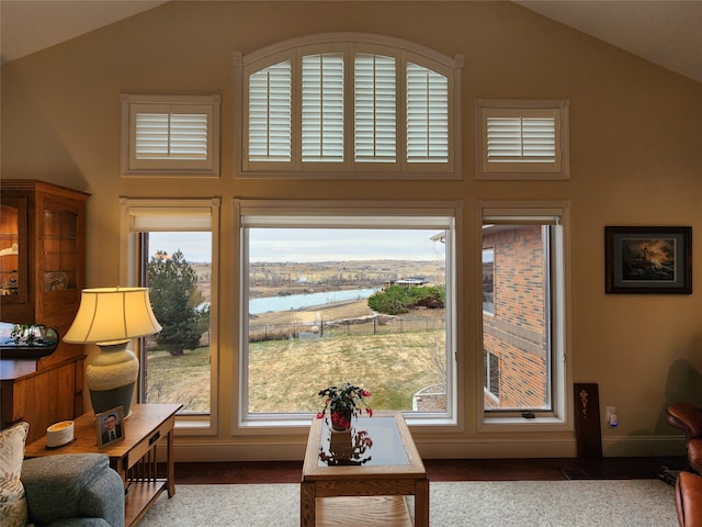 interior space featuring a water view and vaulted ceiling