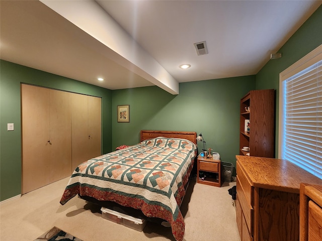 carpeted bedroom with a closet