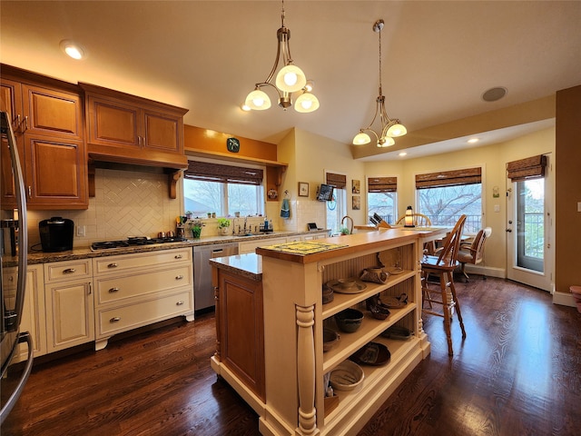 kitchen featuring a chandelier, decorative light fixtures, dark hardwood / wood-style floors, and plenty of natural light