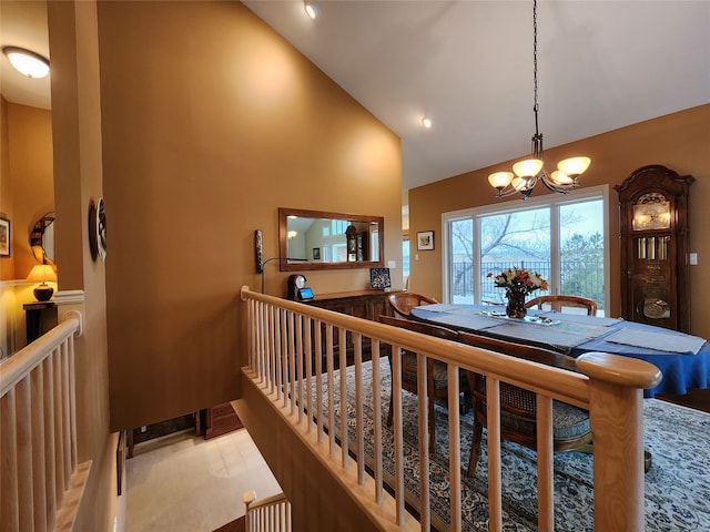 dining room featuring high vaulted ceiling and a chandelier