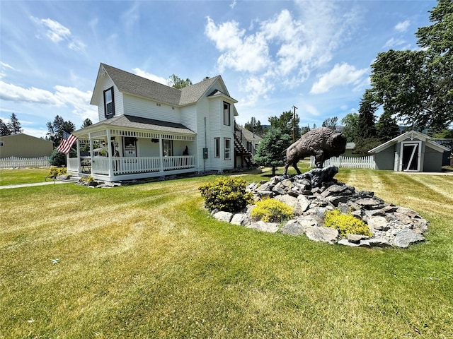 view of side of home with an outbuilding, fence, a lawn, and a storage shed