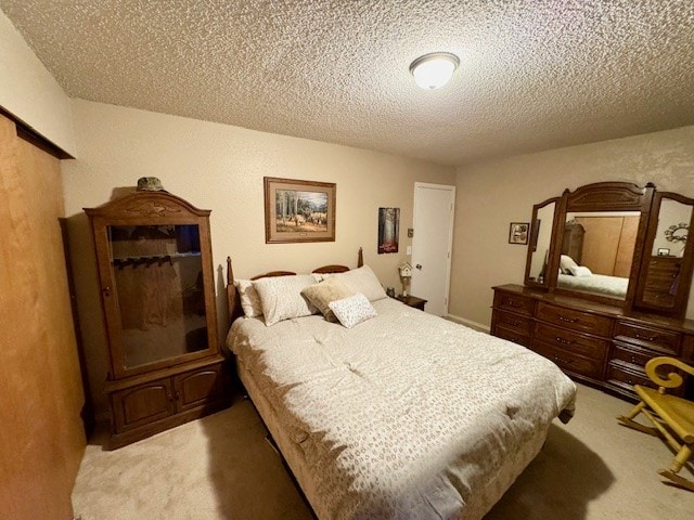 carpeted bedroom featuring a textured ceiling