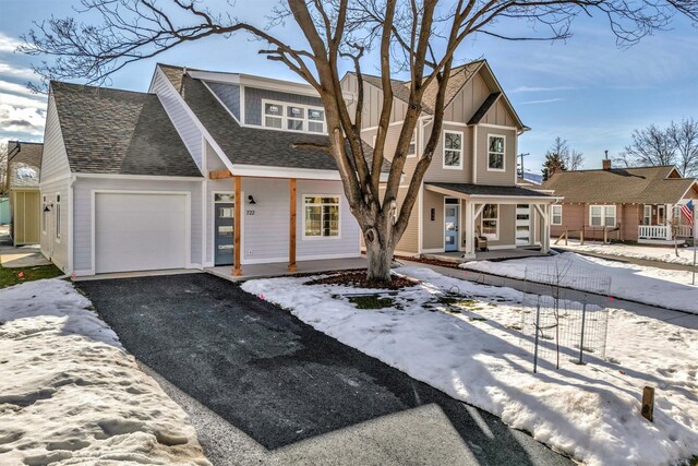 view of front property featuring a garage and a front lawn