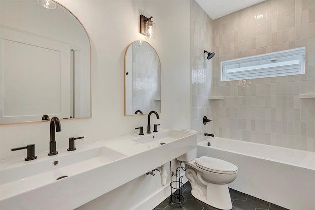 full bathroom featuring shower / washtub combination, a sink, toilet, and tile patterned floors