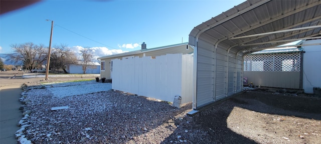 view of side of home with a carport