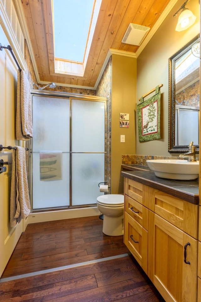 bathroom with vanity, crown molding, hardwood / wood-style flooring, wooden ceiling, and a shower with shower door