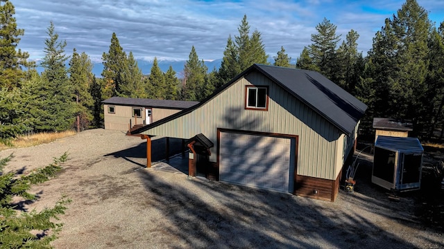 exterior space featuring a garage and an outbuilding