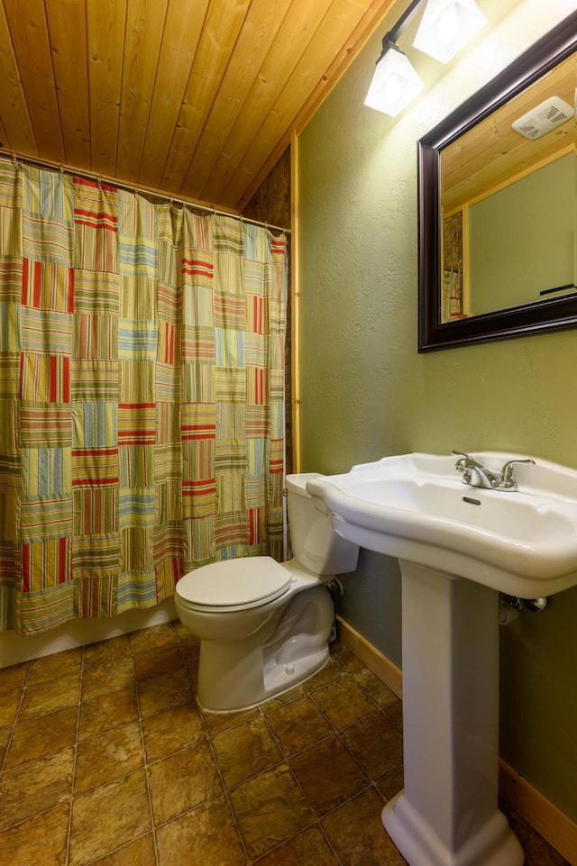 bathroom with tile patterned flooring, toilet, curtained shower, and wood ceiling