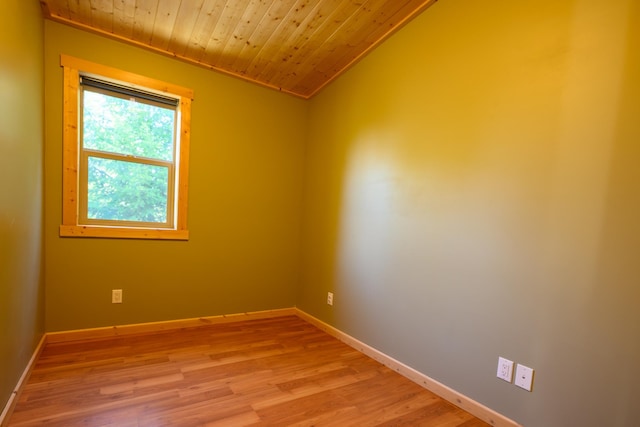 spare room featuring wooden ceiling, lofted ceiling, light hardwood / wood-style floors, and crown molding