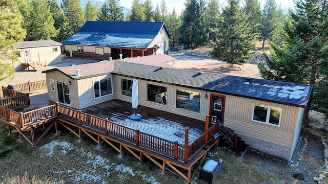 back of house featuring a wooden deck