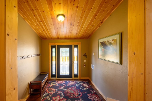 entrance foyer featuring lofted ceiling, ornamental molding, and wooden ceiling