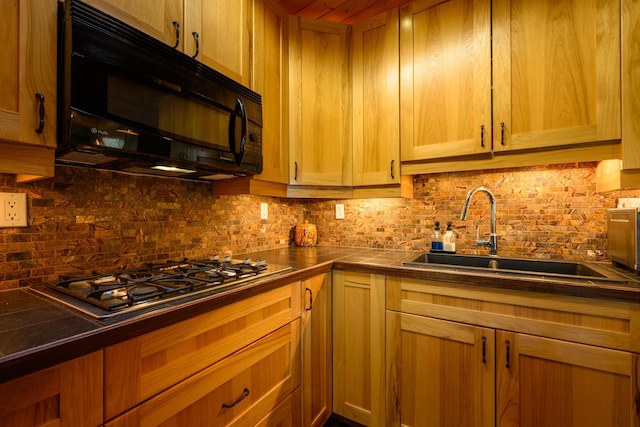 kitchen with backsplash, stainless steel gas cooktop, and sink