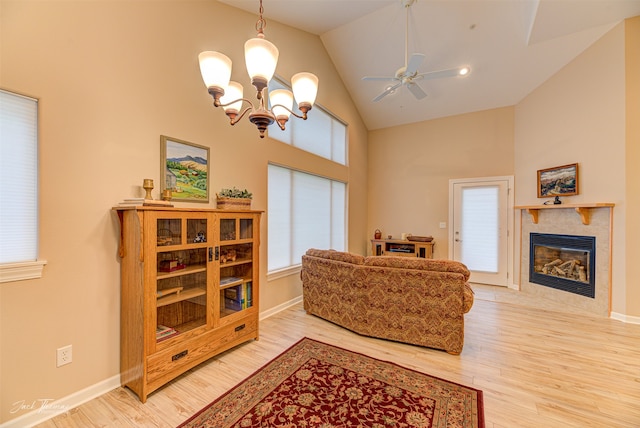 living room featuring hardwood / wood-style floors, ceiling fan with notable chandelier, and a wealth of natural light