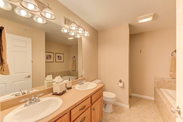 bathroom with tile patterned flooring, vanity, a relaxing tiled tub, and toilet