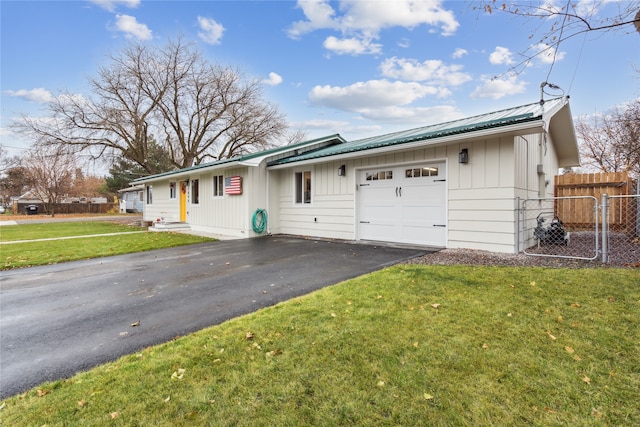 single story home with a front yard and a garage