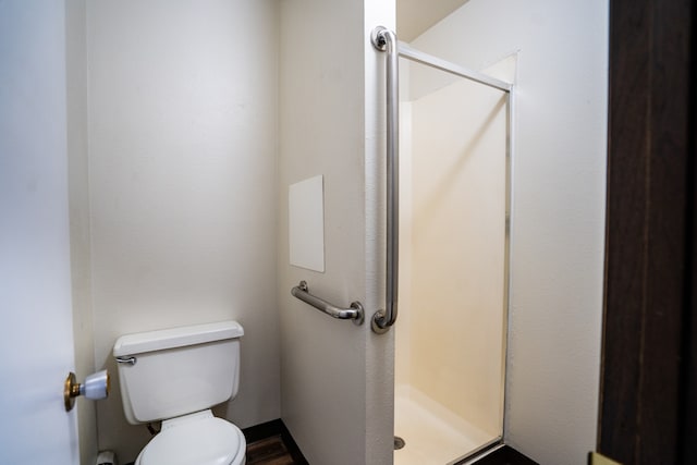 bathroom featuring a shower and toilet