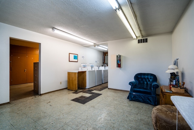 interior space featuring independent washer and dryer and a textured ceiling