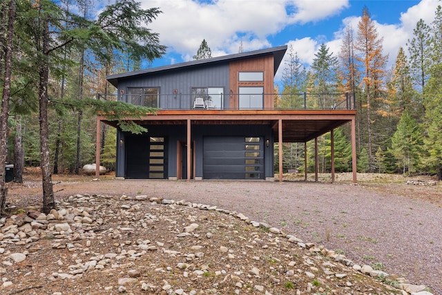 contemporary home with a garage and a wooden deck