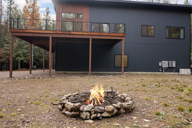 exterior space featuring a wooden deck and an outdoor fire pit